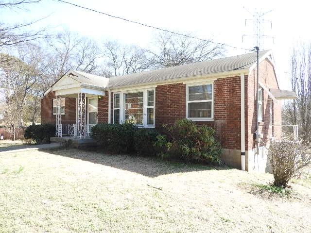 bungalow featuring a porch and brick siding