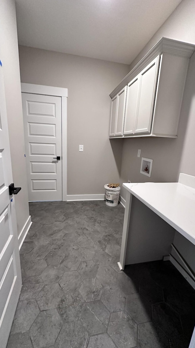 laundry area featuring hookup for a washing machine, cabinet space, and baseboards