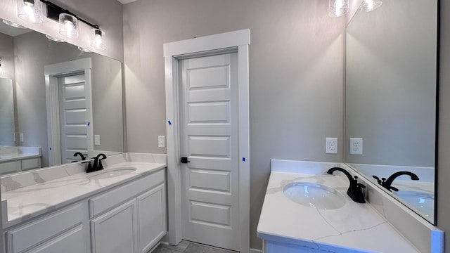 full bath featuring two vanities and a sink