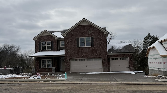 traditional-style house featuring brick siding and driveway