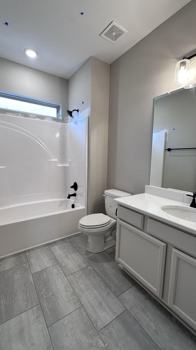 full bathroom with toilet, visible vents, shower / washtub combination, and vanity