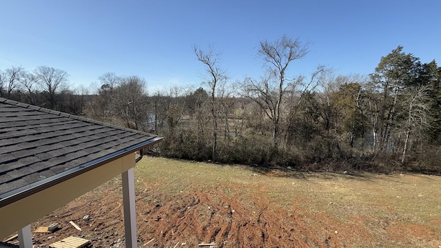 view of yard with a view of trees