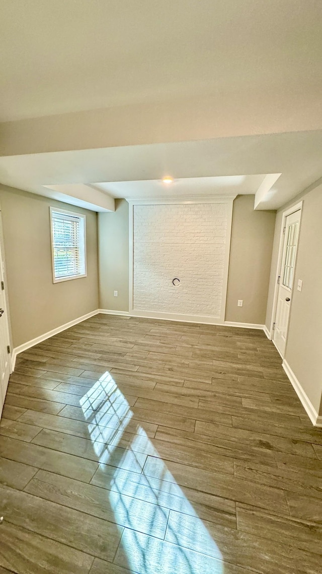 interior space featuring baseboards and wood finished floors