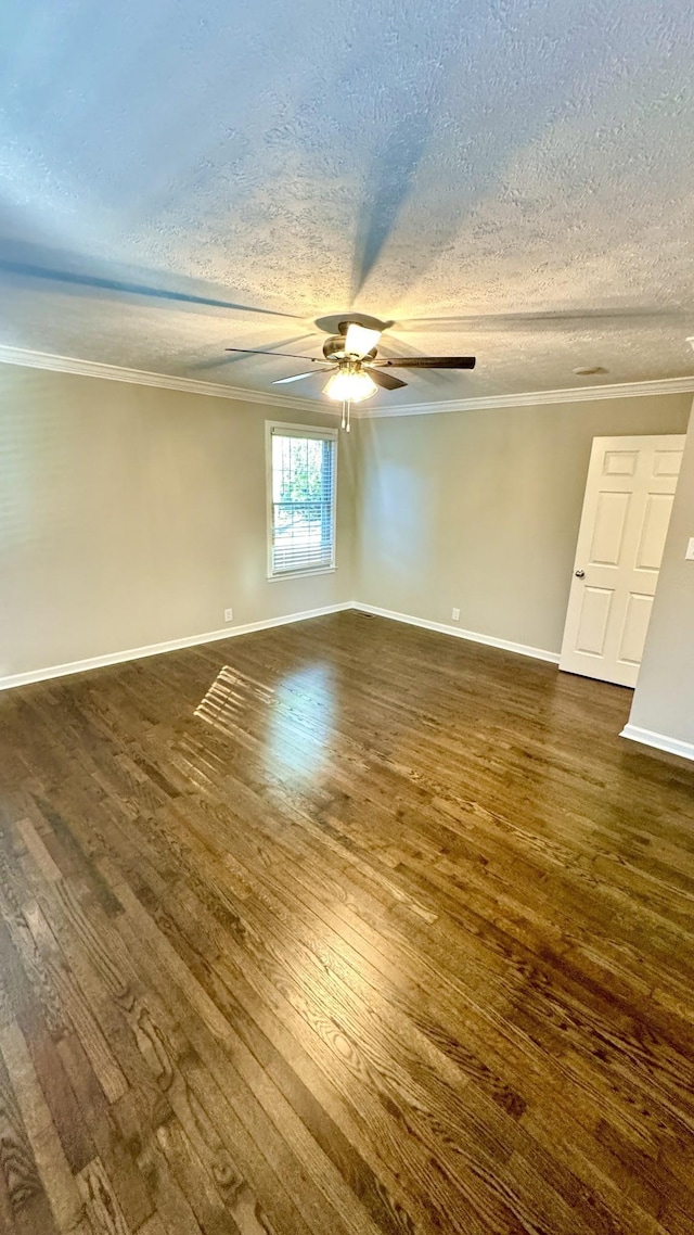 unfurnished room with baseboards, a ceiling fan, dark wood-style floors, ornamental molding, and a textured ceiling