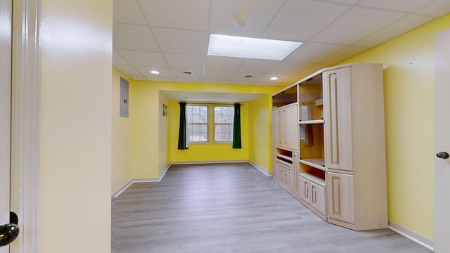 mudroom with baseboards, a paneled ceiling, and light wood-style floors