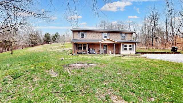 traditional home with a front lawn and brick siding