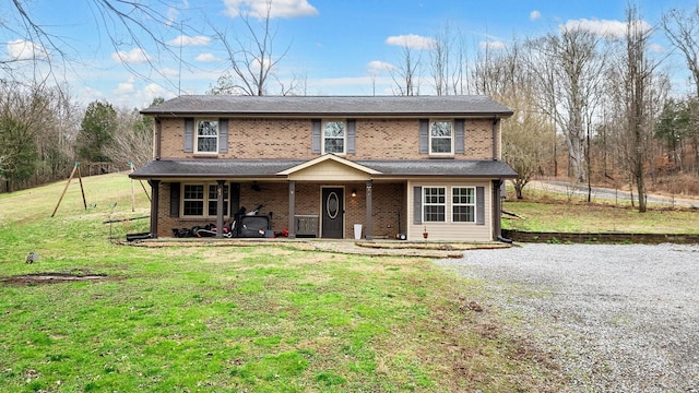 traditional-style home with brick siding and a front yard