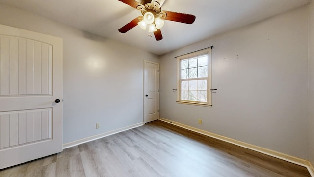 unfurnished bedroom with a ceiling fan, baseboards, and wood finished floors