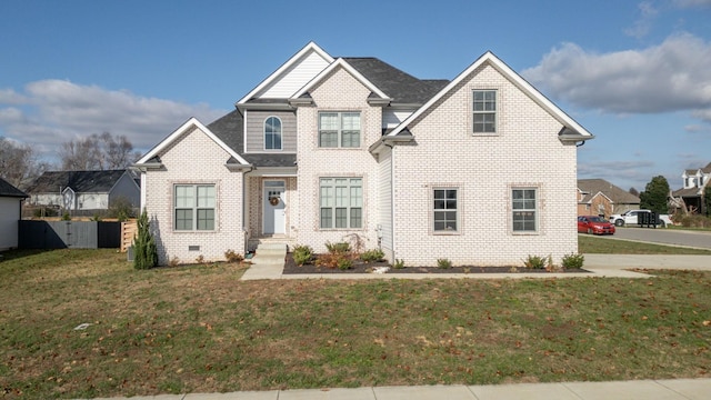 view of front of home with a front lawn and brick siding