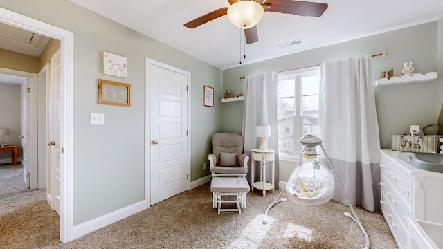 sitting room with light carpet, ceiling fan, visible vents, and baseboards