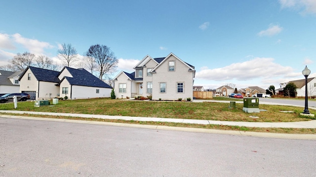 traditional-style home featuring a residential view and a front lawn