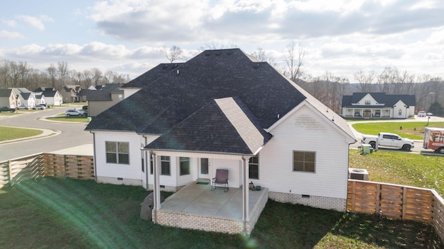 back of property with crawl space, a patio area, fence, and a lawn