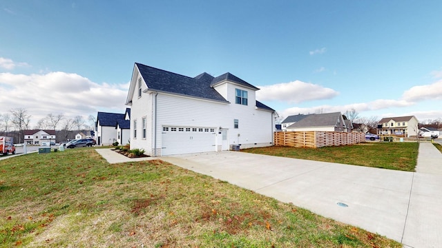 view of property exterior featuring an attached garage, concrete driveway, and a yard