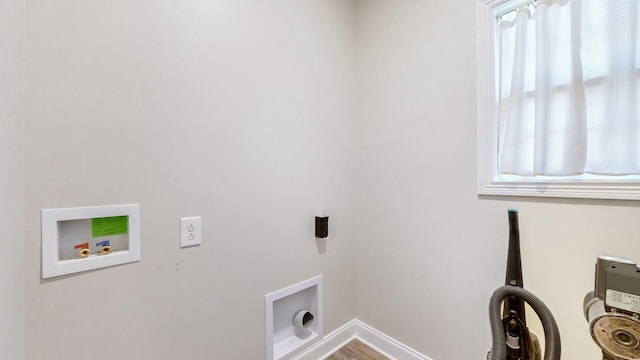 clothes washing area featuring laundry area, wood finished floors, hookup for a washing machine, and baseboards