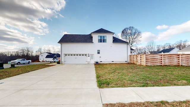 view of side of home featuring a garage, a lawn, concrete driveway, crawl space, and fence