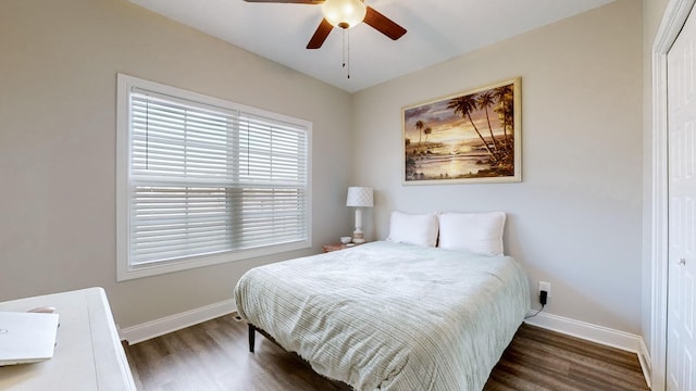 bedroom with ceiling fan, baseboards, and wood finished floors