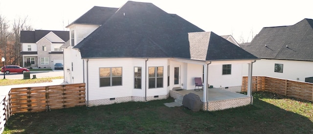 back of property featuring a yard, a shingled roof, crawl space, a patio area, and fence