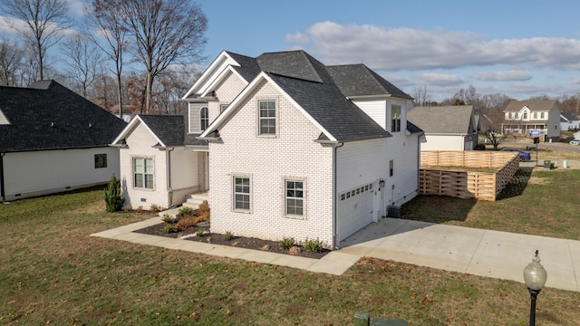 exterior space with brick siding, a lawn, concrete driveway, and roof with shingles