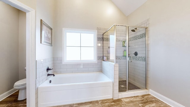 full bathroom featuring a garden tub, toilet, vaulted ceiling, a shower stall, and baseboards