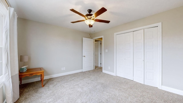 unfurnished bedroom featuring carpet, a closet, ceiling fan, and baseboards