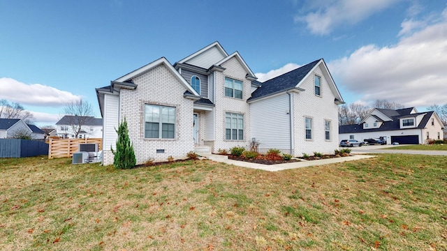 view of front of house with a front lawn, cooling unit, fence, and brick siding