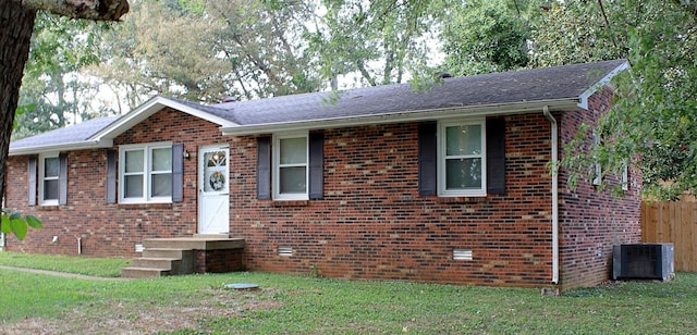 single story home with central AC unit, crawl space, fence, a front lawn, and brick siding