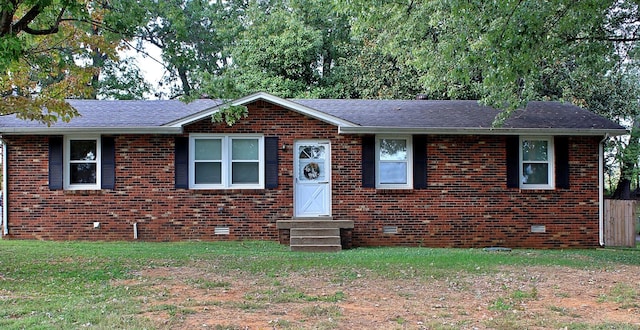 view of front of house with roof with shingles, brick siding, crawl space, and a front lawn