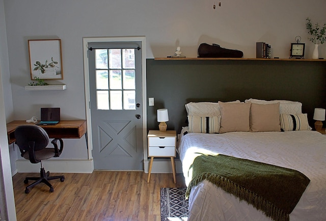 bedroom featuring wood finished floors and baseboards