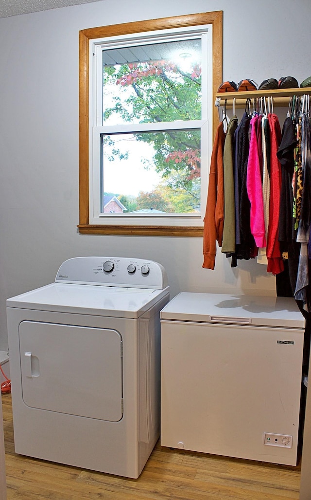 washroom with laundry area, light wood-style flooring, and washer and dryer