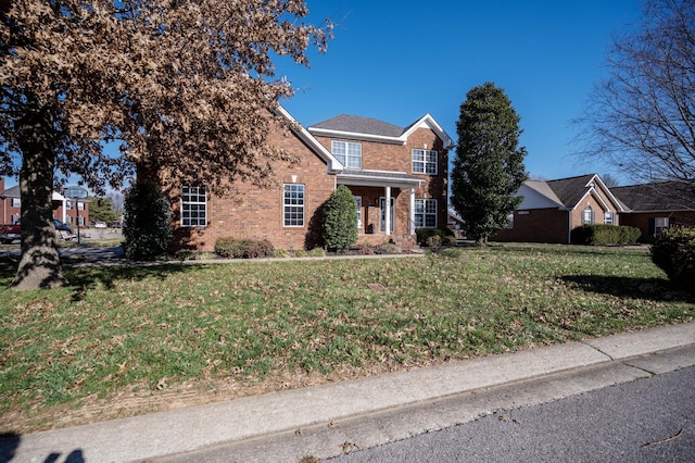 view of front of house with brick siding and a front lawn