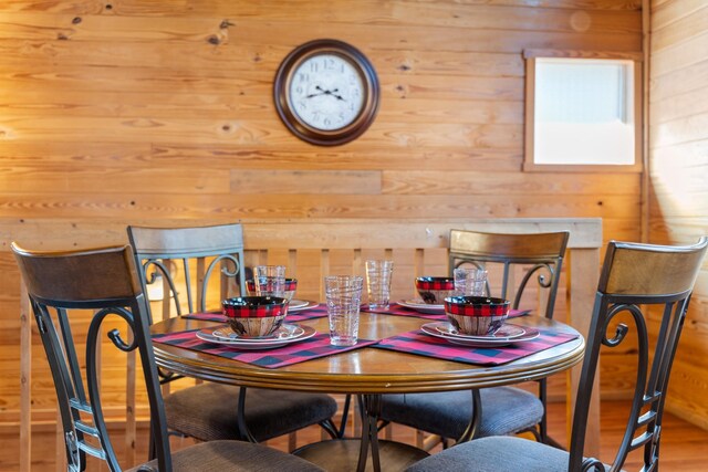 dining space featuring wooden walls