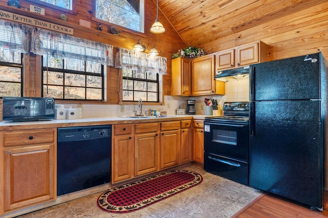 kitchen featuring lofted ceiling, under cabinet range hood, a sink, light countertops, and black appliances