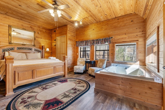 bedroom with wood walls, wood finished floors, and wood ceiling