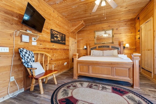 bedroom with wooden ceiling and dark wood-style flooring