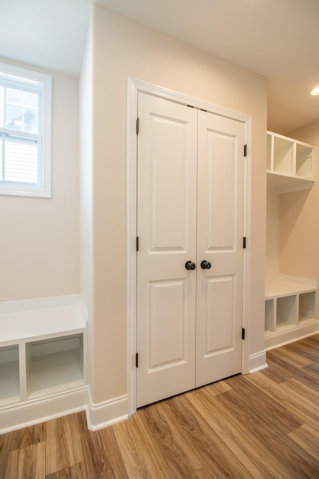 mudroom with baseboards and wood finished floors