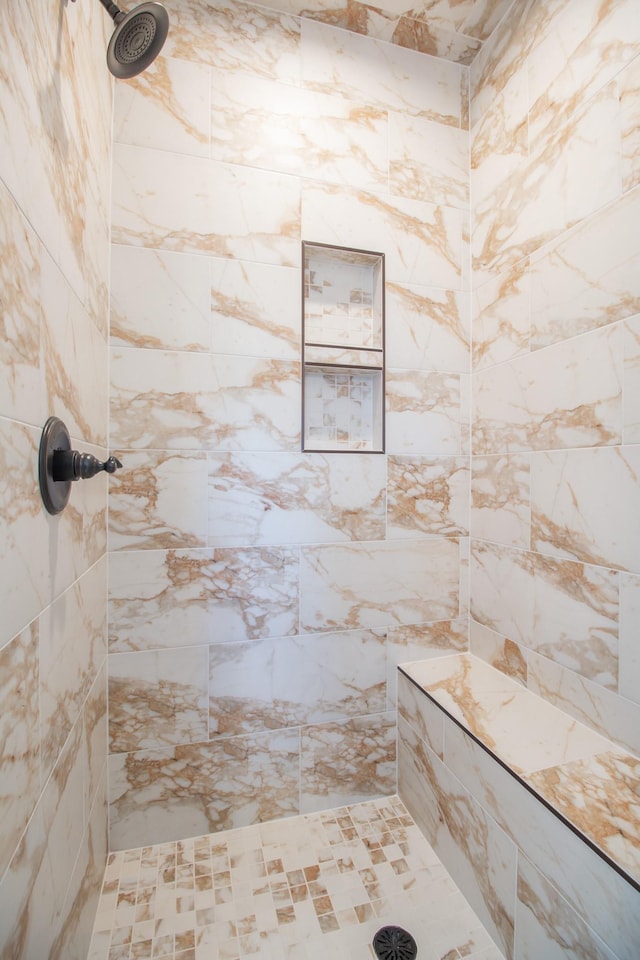 bathroom with a tile shower