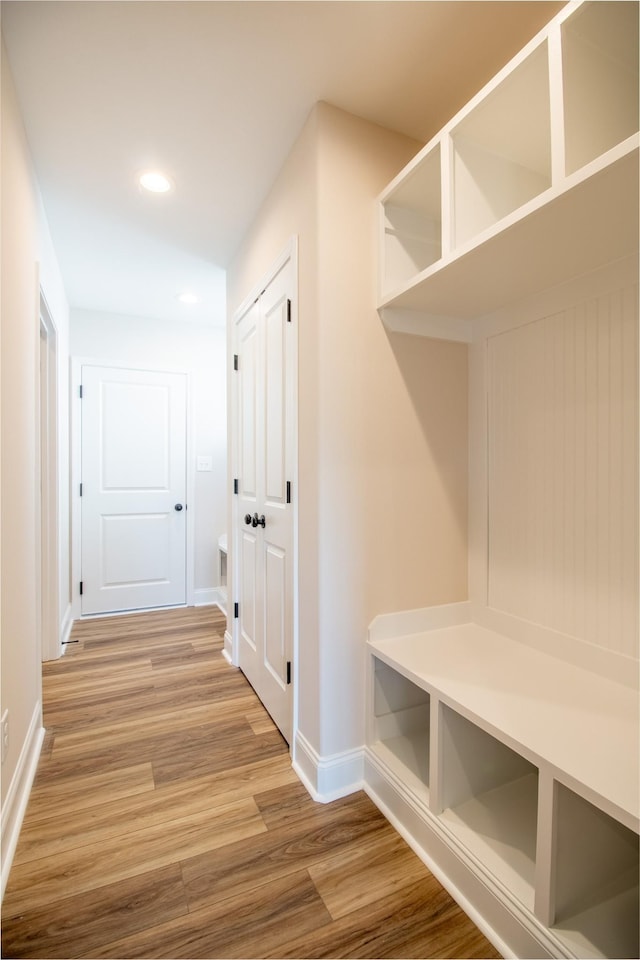 mudroom featuring baseboards, wood finished floors, and recessed lighting