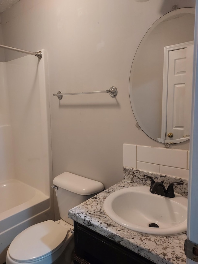 full bathroom featuring shower / tub combination, vanity, and toilet