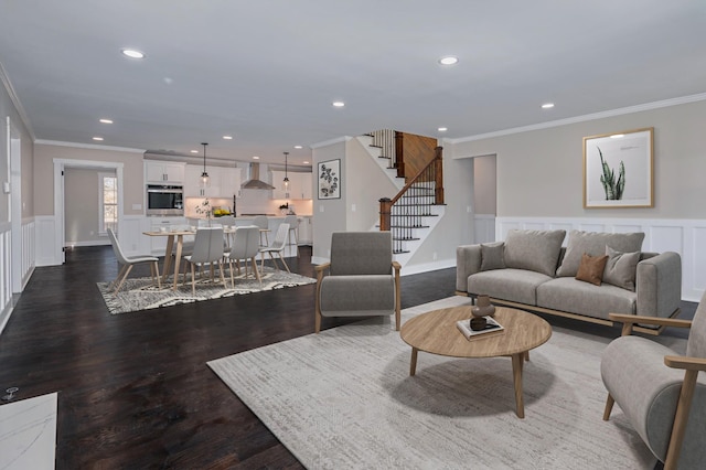 living area featuring recessed lighting, stairs, crown molding, and wainscoting