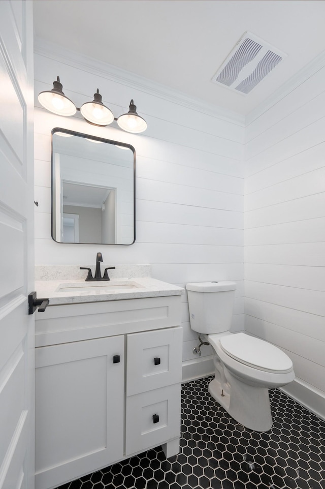 bathroom featuring ornamental molding, visible vents, vanity, and toilet