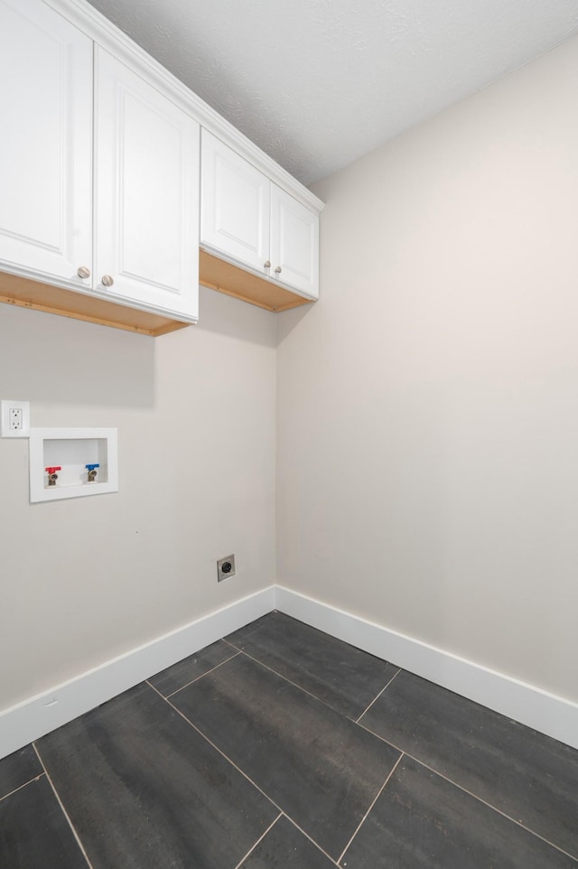 washroom featuring baseboards, hookup for a washing machine, cabinet space, and electric dryer hookup