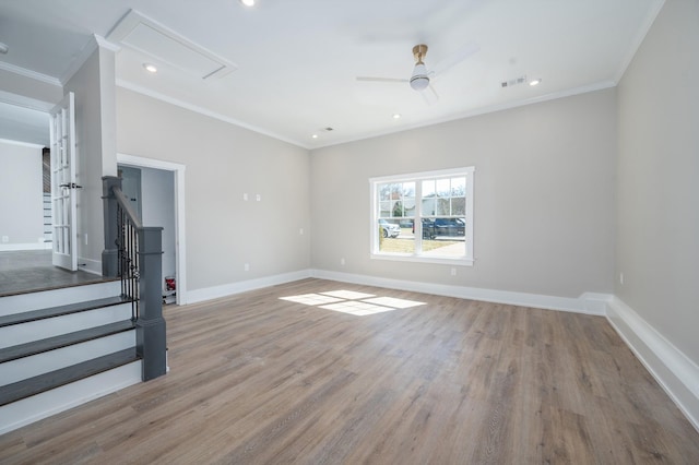 unfurnished living room featuring visible vents, baseboards, light wood-style flooring, and crown molding