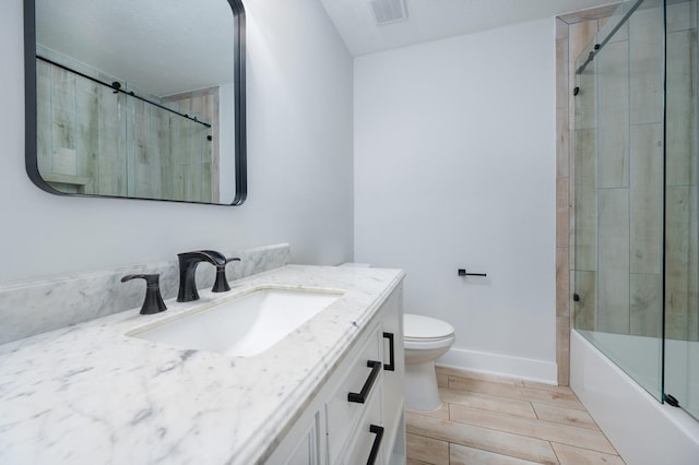 full bath with visible vents, toilet, wood tiled floor, vanity, and baseboards