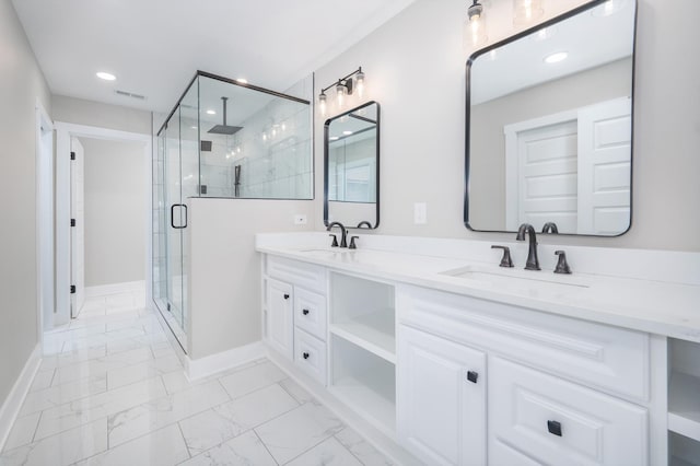 bathroom featuring marble finish floor, a stall shower, a sink, and baseboards