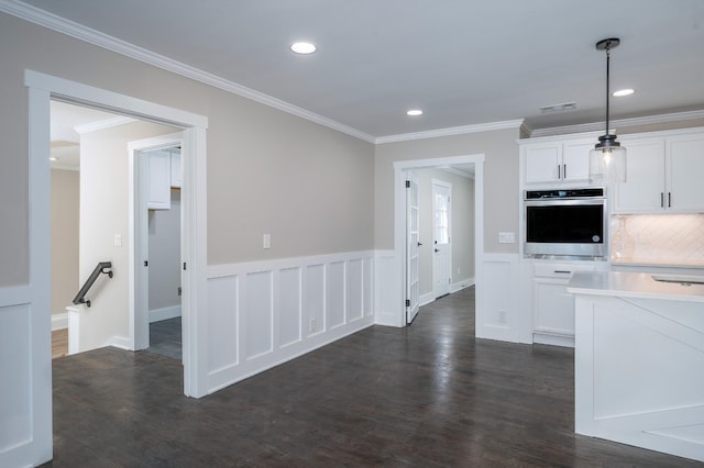 kitchen featuring dark wood finished floors, light countertops, visible vents, white cabinets, and oven