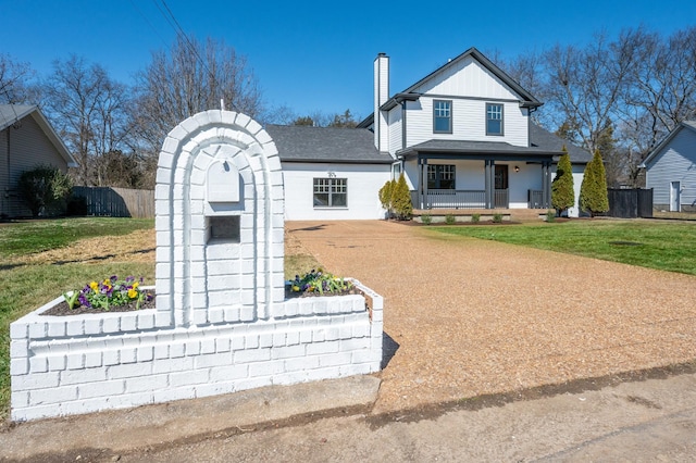 modern farmhouse style home with a chimney, a porch, concrete driveway, a front yard, and fence