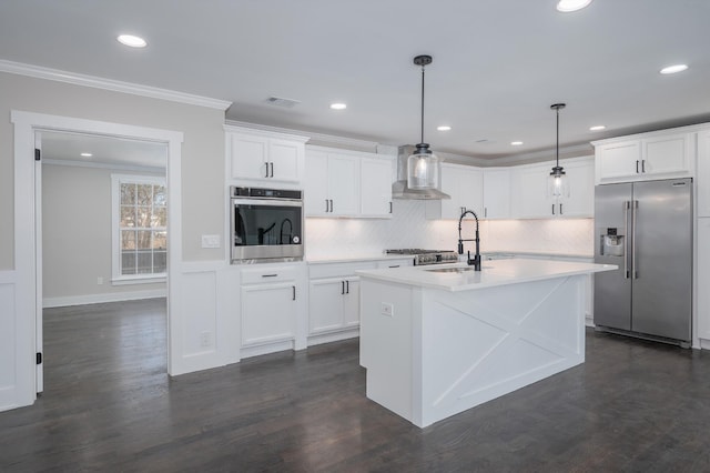 kitchen with ornamental molding, light countertops, appliances with stainless steel finishes, and a sink