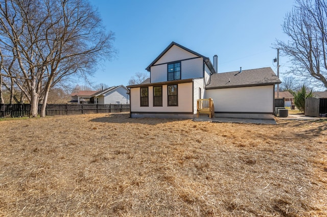 rear view of property featuring central air condition unit, a patio area, and fence