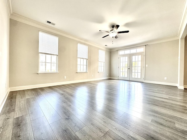 empty room with visible vents, dark wood finished floors, ceiling fan, ornamental molding, and french doors