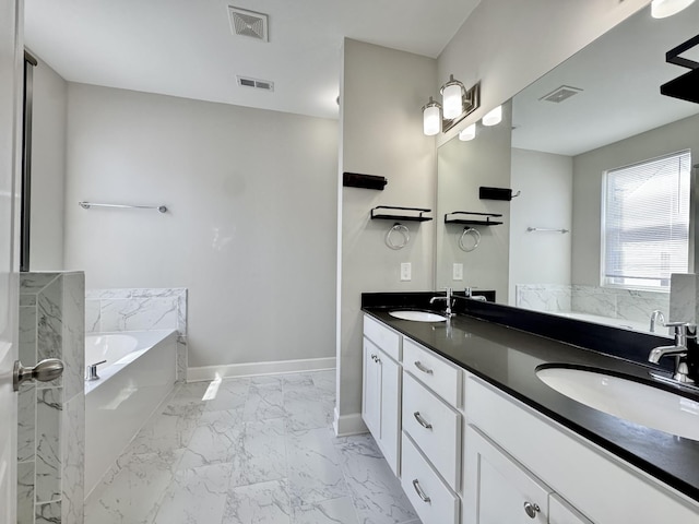 full bath with marble finish floor, visible vents, a garden tub, and a sink